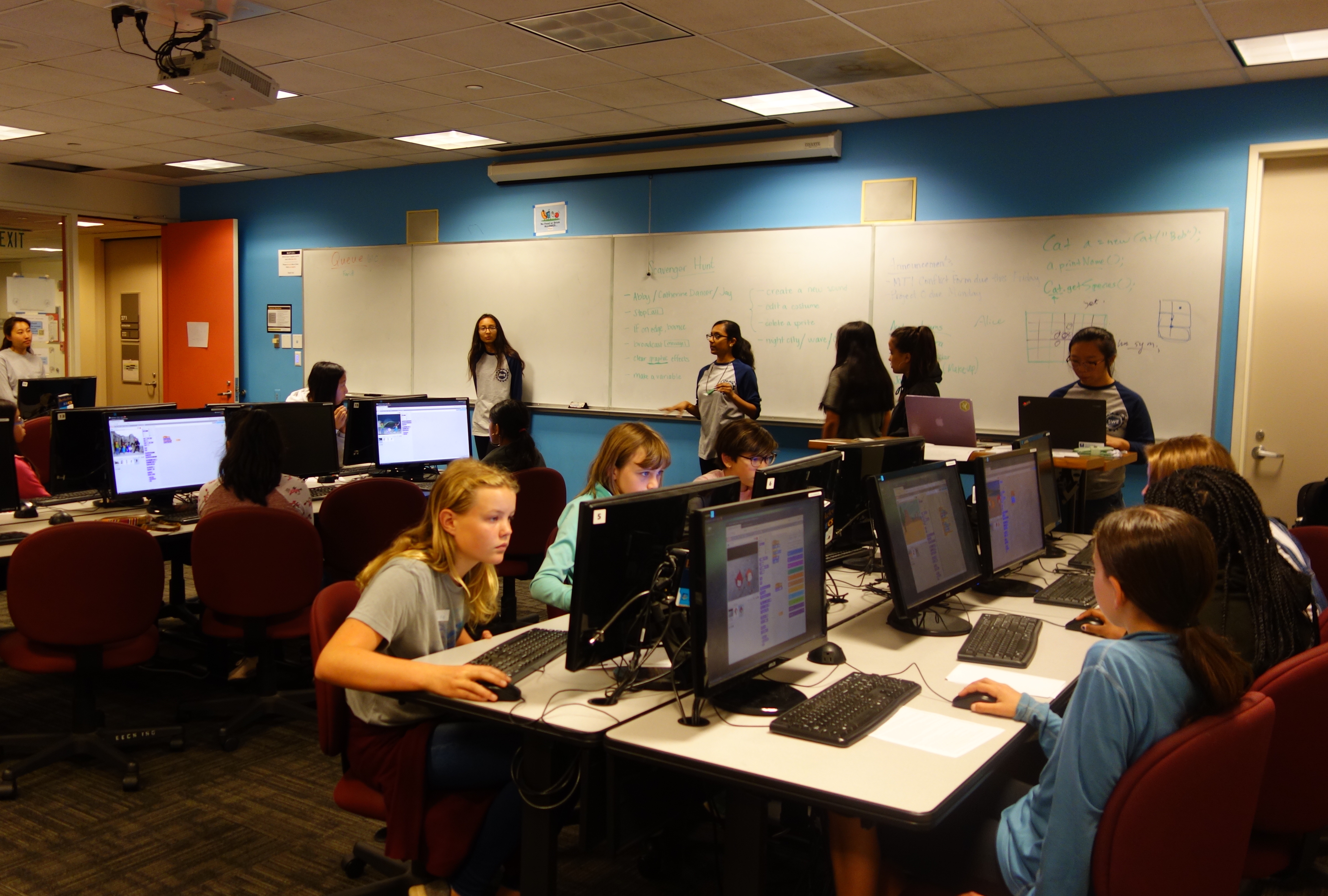 Students working with Scratch in computer science lab.